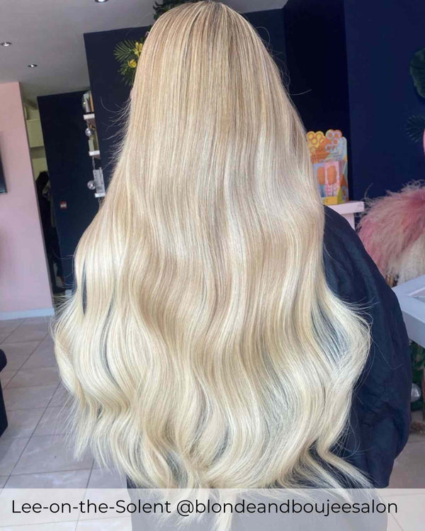 Root Stretch dark blonde to bright blonde hair achieved with Viola human hair extensions, warm blonde blending into platinum blonde hair
