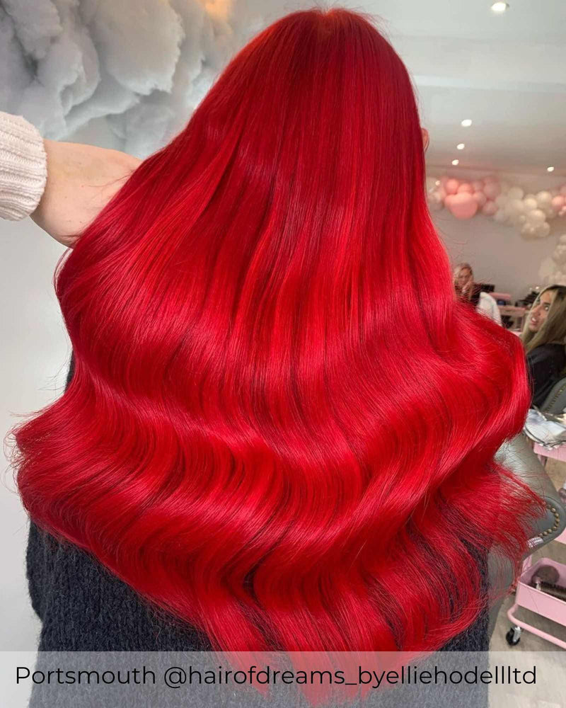 Bright red hair, achieved with Viola bold, beautiful, red hair extensions in nano rings adding length and volume to red hair